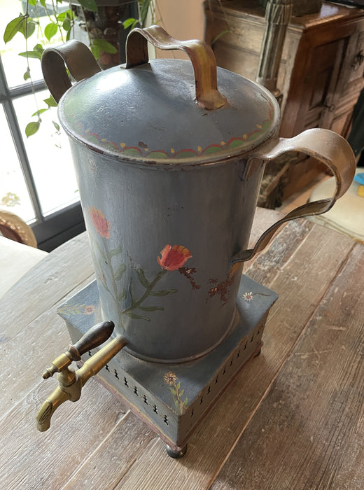Antique tall tea kettle with tap.