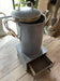 Antique tall tea kettle with tap.